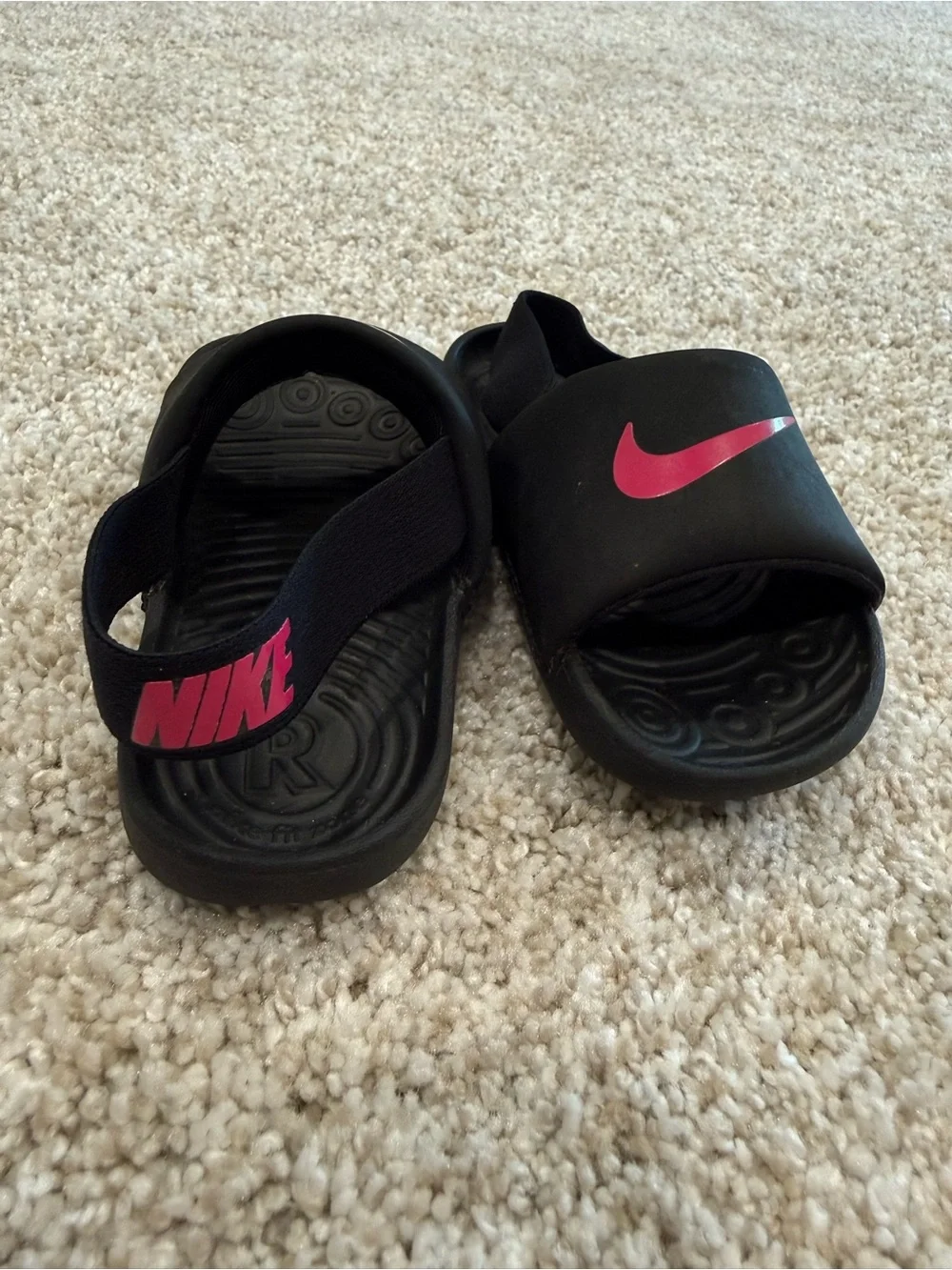 Nike Kids Black Slide Sandals with Pink Swoosh Accent